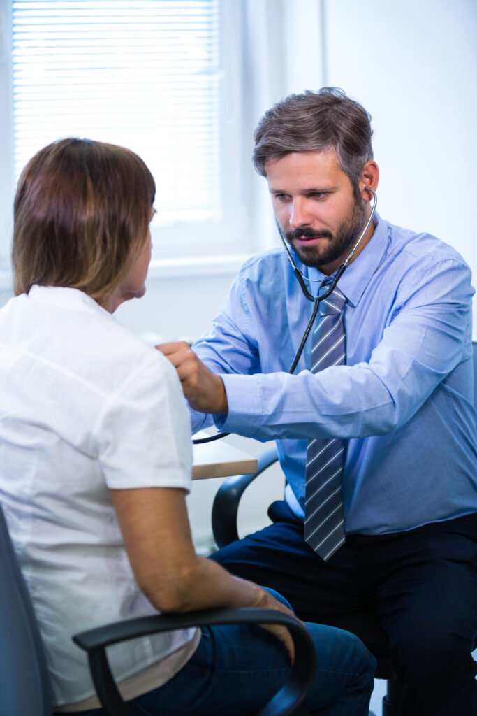 male doctor examining a patient
